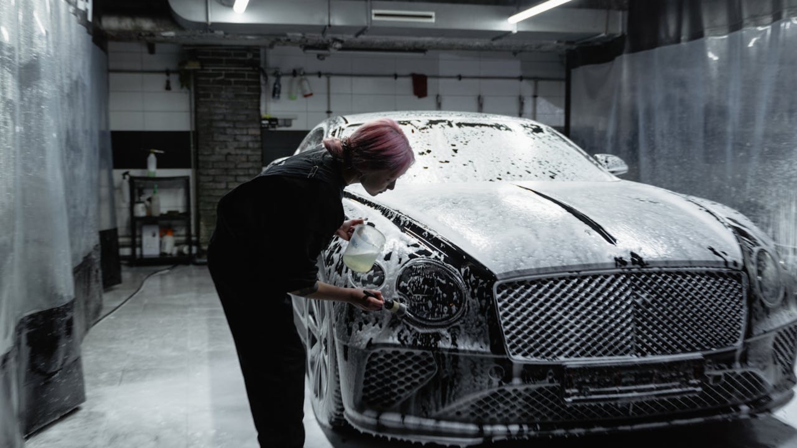 A Woman Washing a Luxury Car